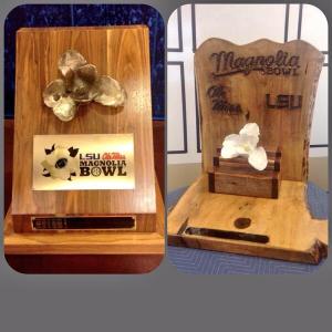 In recent years, the winner of the LSU-Ole Miss game has taken home the Magnolia Bowl Trophy.  The magnolia is the state flower of both Louisiana and Mississippi.  Apparently, Ole Miss destroyed the original in 2013, so the new one is the one on the right.