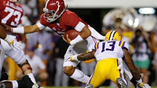 Alabama QB Jalen Hurts attempts to avoid a sack.